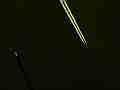 Darkened zoomed jet leaves real-time trail � digitally upscaled timelapse scene from Stitching the Sky Cat.#V00359x, 1280x720 Motion JPEG (.AVI), 7 sec. at 30fps 