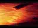 Catalog#:V01729 License:$56.00, Format:720x480 Motion JPEG(.AVI) at 30fps, Length: approx.9 sec. Orange-red backlit stratus wave, zoom timelapse