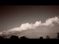 Catalog#:V08909 License:$100.00, Format:1920x1080 Motion JPEG(.AVI) at 30fps, Length: approx.20 sec. Lenticular tubes rolling with cumulus foreground (sepia) timelapse